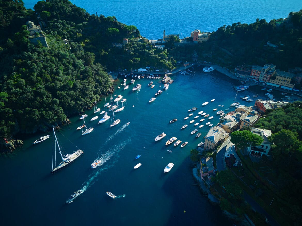 Boats resting in Portofino harbor — quiet color, morning light, and calm sea air.